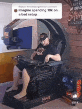 a man is sitting in a savage gaming chair with a keyboard