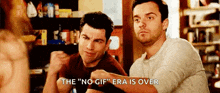 two men are sitting at a table with their hands in the air and one of them is saying `` the no gif era is over '' .