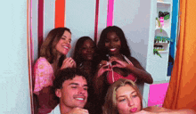 a group of people posing for a picture in a photo booth .