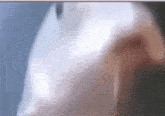 a blurry picture of a person 's face with a tear coming out of their nose
