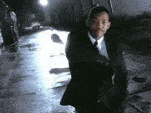 a man in a suit and tie walking down a street