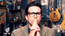 a man wearing glasses is making a silly face