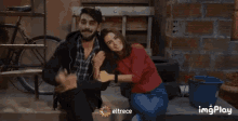 a man and a woman are sitting next to each other with eltrece written on the bottom