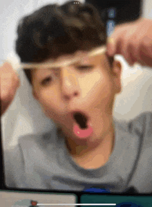a blurry picture of a person with their mouth open and a rubber band around their head