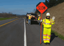 Slow Down Sign GIF - Slow Down Sign Flagger GIFs