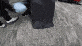 a group of people standing around a black bag