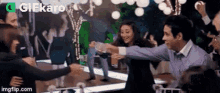 a group of people are dancing together at a party in a restaurant .