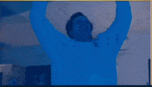 a man in a blue shirt is standing next to a woman in a blue shirt .