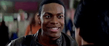 a young man in a leather jacket is smiling at a woman .