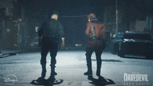 a poster for daredevil born again shows two men standing on a street at night