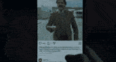 a person is holding a cell phone with cnn written on it