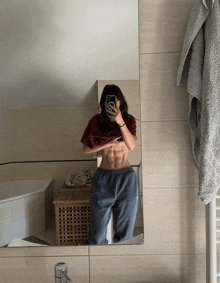 a woman taking a picture of herself in the mirror
