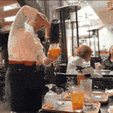 a woman is pouring a drink into a glass