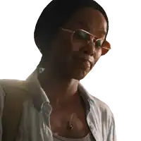 a woman wearing glasses and a necklace has a backpack on her back