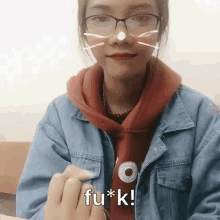 a girl wearing glasses and a denim jacket is saying fu * k