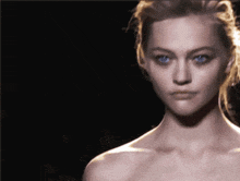 a close up of a woman 's face in the dark