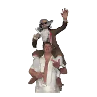a man is riding another man on his shoulders while waving