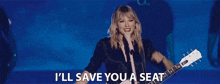 taylor swift is singing into a microphone while holding a guitar and saying `` i 'll save you a seat ''
