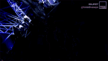 a person is standing in a dark room with a blue light behind them .