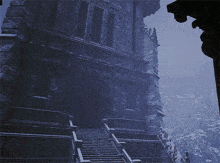 a stone building with stairs leading up to it in the fog