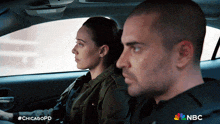 a man and a woman sitting in a car with #chicagopd written on the bottom