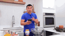 a man in a blue shirt is using a cell phone