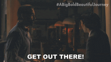 two men are shaking hands and one of them says " get out there "