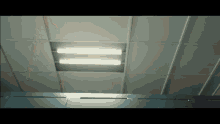 a ceiling with a few lights on it and a blue wall
