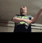 a man with a beard is wearing a shirt that says more