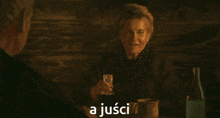 a woman sitting at a table with a glass of water and the words a jusci on the bottom