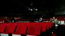 two police officers are shooting guns in an auditorium