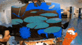 a man is painting a painting of water lilies
