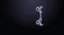 a stream of water is splashing on a black surface