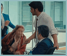 a man in a white shirt is talking to a woman in a red scarf