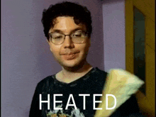 a man with glasses is holding a piece of paper that says heated on it