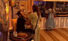 a woman is kissing a man on the forehead in a room .