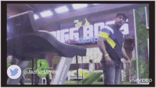a man is running on a treadmill in front of a sign that says big boss