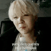 a young man drinking from a bottle with the words " yumi dice que soy muy hermoso " written below him