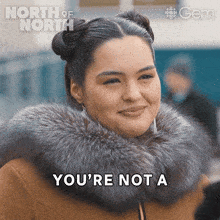 a woman wearing a fur coat says you 're not a on the screen