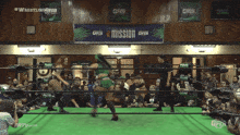 two women in a wrestling ring with a sign that says mission on it