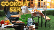 a person holding a can of busch light beer in front of a grill