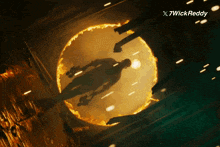 a picture of a man in a fire circle with 7wickreddy written on the bottom right