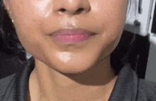 a close up of a woman 's face with a lot of oil on her face .