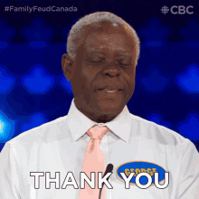 a man wearing a white shirt and a pink tie says thank you