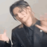 a blurry picture of a man in a suit and tie making a funny face .