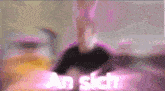 a blurred image of a person with the word an sich written in pink