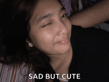 a girl laying on a bed with the words sad but cute on her face