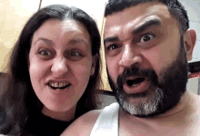 a man with a beard is making a funny face with a woman