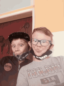 a boy wearing a paris saint-germain jacket and a boy wearing glasses