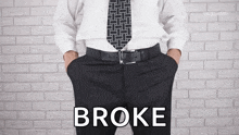 a man with his hands in his pockets and the word broke written on his pants